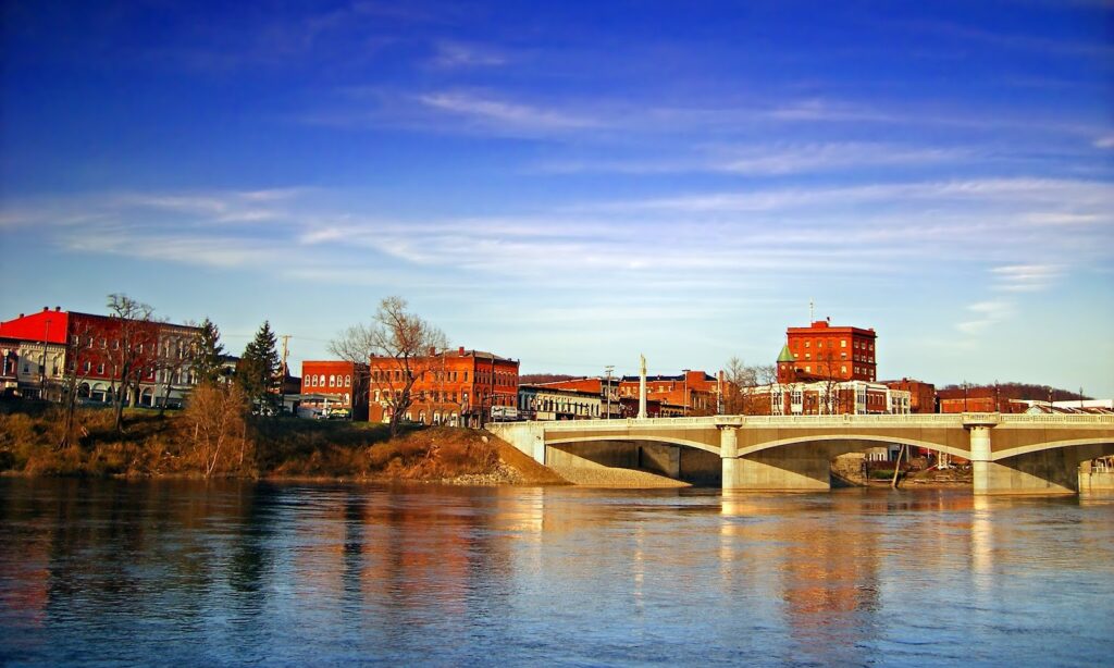 This image shows the Hickory Street Bridge spanning the Allegheny River in Warren, Pennsylvania.